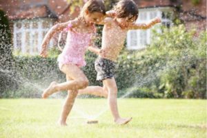 Children Run through the Sprinklers - PHD Mechanical Inc